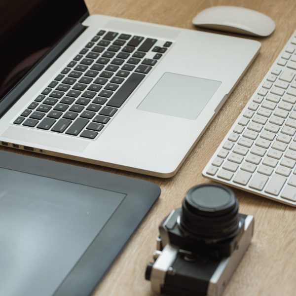 Business workplace with laptop and gadgets on wooden background